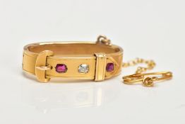 A LATE VICTORIAN GOLD, DIAMOND AND RUBY SCARF CLIP, of buckle design, set with an old cut diamond