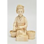 A JAPANESE MEIJI PERIOD IVORY OKIMONO, of a kneeling female figure surrounded by a wooden bucket,