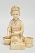 A JAPANESE MEIJI PERIOD IVORY OKIMONO, of a kneeling female figure surrounded by a wooden bucket,