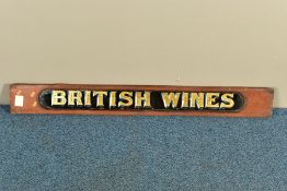 A LATE VICTORIAN WALNUT FRAMED REVERSE PAINTED ON GLASS 'BRITISH WINES' SIGN, the walnut surround