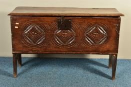 A 17TH CENTURY OAK BOARDED SIX PLANK CHEST, the front with triple matching circular carvings