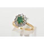 AN 18CT GOLD MID TO LATE TWENTEITH CENTURY EMERALD AND DIAMOND CLUSTER RING, centring on an oval