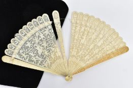 A LATE 18TH / EARLY 19TH CENTURY CHINESE IVORY BRISE FAN, the guard sticks carved in relief with