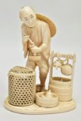 A JAPANESE MEIJI PERIOD IVORY OKIMONO, of a man standing beside a large bucket with turtle and