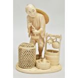 A JAPANESE MEIJI PERIOD IVORY OKIMONO, of a man standing beside a large bucket with turtle and