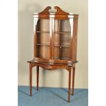 A SHERATON REVIVAL MAHOGANY AND MARQUETRY PAINTED SERPENTINE BOOKCASE ON STAND, decorated with