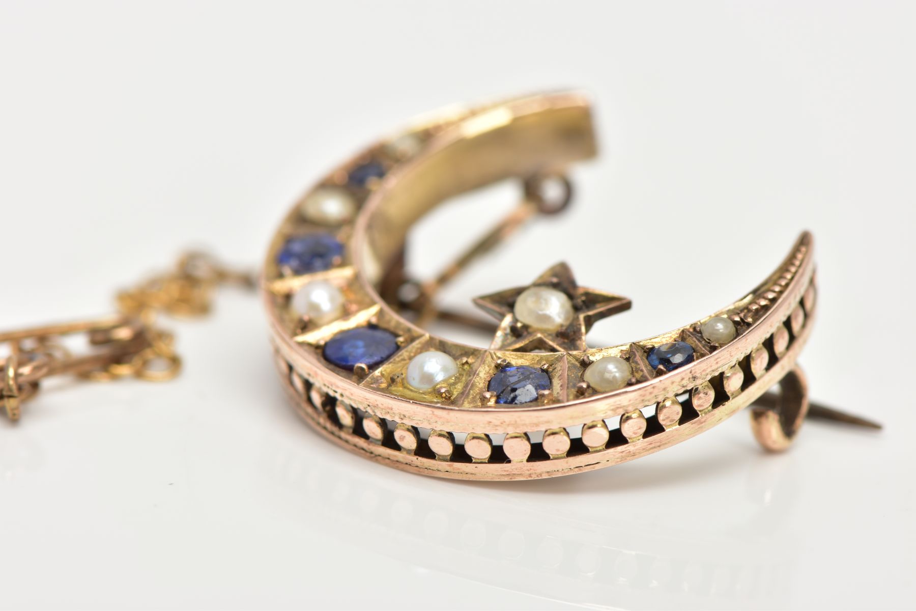 A LATE VICTORIAN 9CT GOLD SAPPHIRE AND SPLIT PEARL CRESCENT BROOCH, designed as circular sapphires - Image 6 of 7
