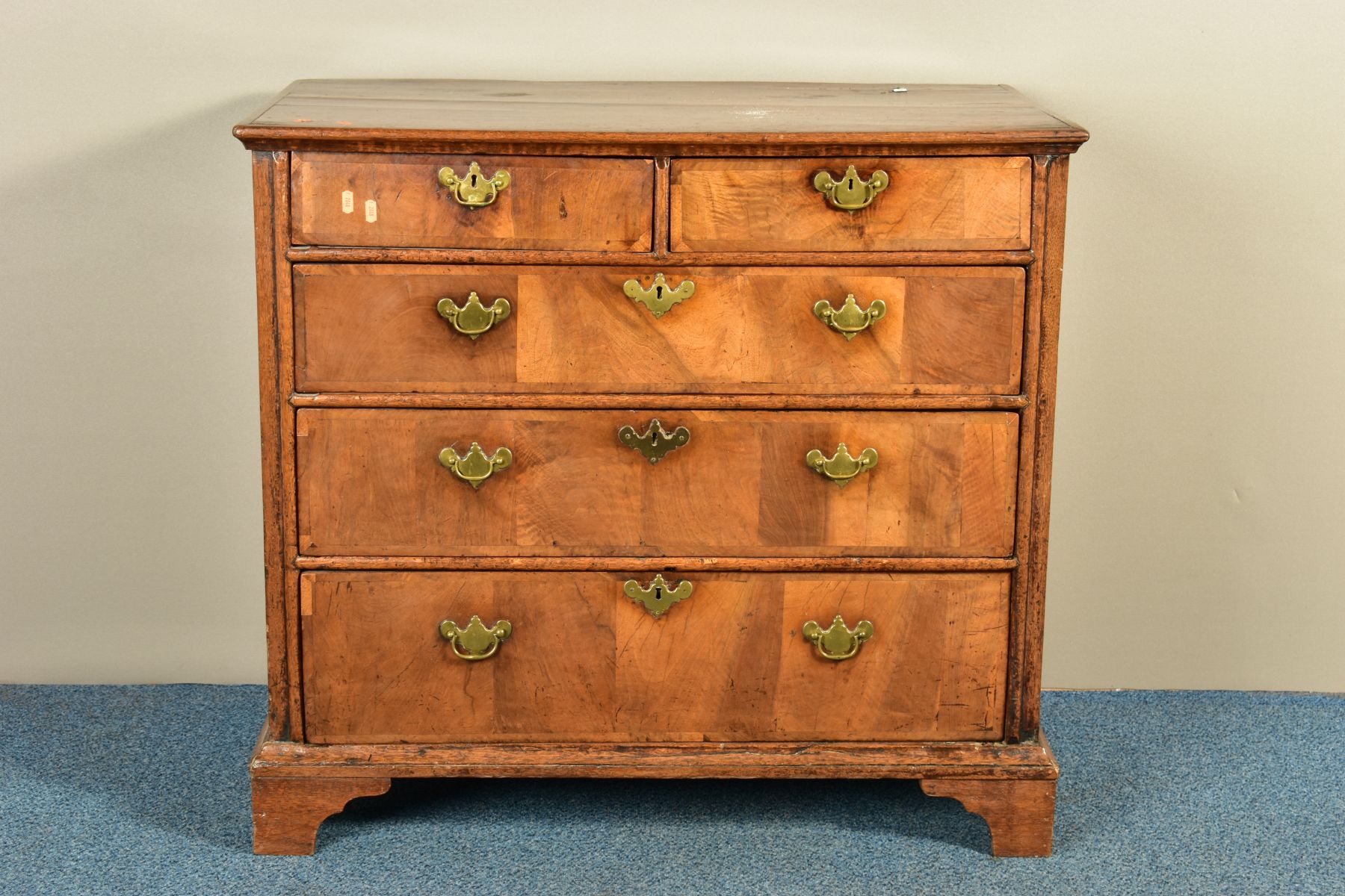 A GEORGE I AND LATER OAK CHEST OF TWO SHORT OVER THREE LONG GRADUATED DRAWERS, the drawer fronts