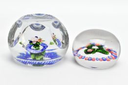 TWO 19TH CENTURY GLASS PAPERWEIGHTS, possibly St. Louis, comprising an example with small bouquet
