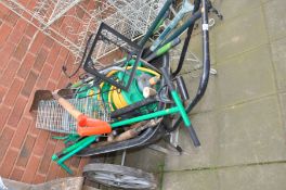 A LARGE WHEELED GARDENING WHEEL BARROW, and a quantity of garden tools and hose reels