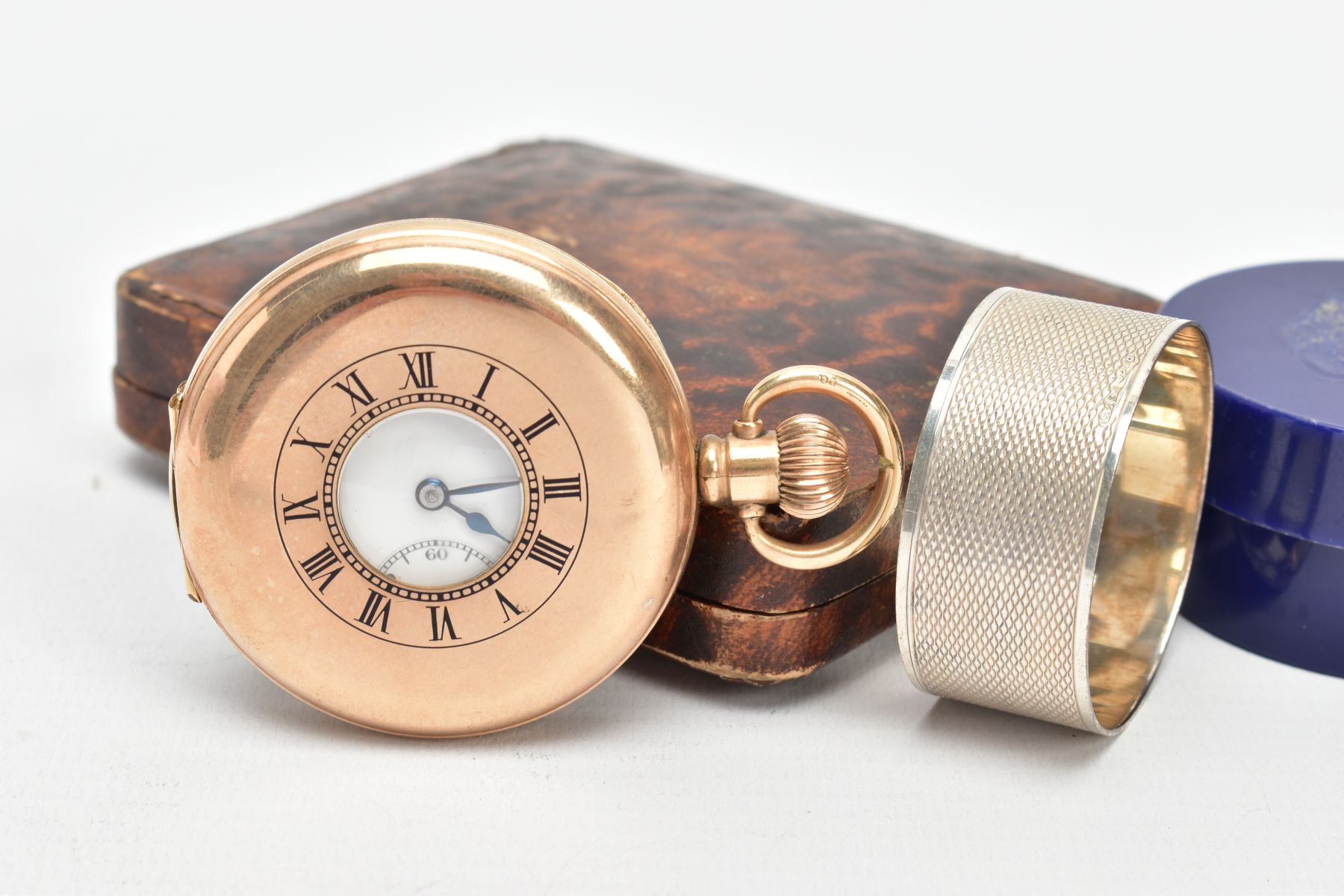A GOLD-PLATED HALF HUNTER POCKET WATCH AND A SILVER NAPKIN RING, round white dial signed '