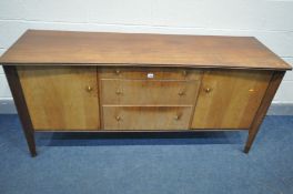 AN 'A YOUNGER LTD' TEAK CONCAVE SIDEBOARD, with double cupboard doors, flanking three graduated