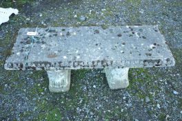 A COMPOSITE GARDEN BENCH with a rectangular top, 120cm long, standing on scrolled bases