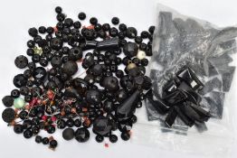 A BAG OF LOOSE BEADS, to include various faceted jet ball beads, a single carved jet drop earring
