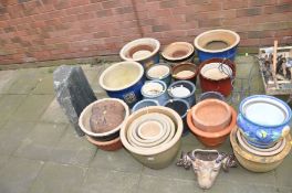 A QUANTITY OF GLAZED AND TERRACOTTA PLANT POTS, 30 plus and a granite slab height 56cm with a hole