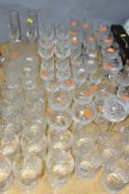 A QUANTITY OF CUT CRYSTAL AND OTHER SETS OF DRINKING GLASSES, approximately sixty four tumblers,