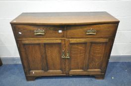 AN ARTS AND CRAFTS OAK SIDEBOARD, with two drawers over double cupboard doors, width 117cm x depth