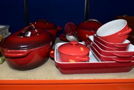 A GROUP OF RED KITCHENAID COOKWARES, twelve pieces comprising an enamel oval casserole dish,
