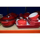 A GROUP OF RED KITCHENAID COOKWARES, twelve pieces comprising an enamel oval casserole dish,