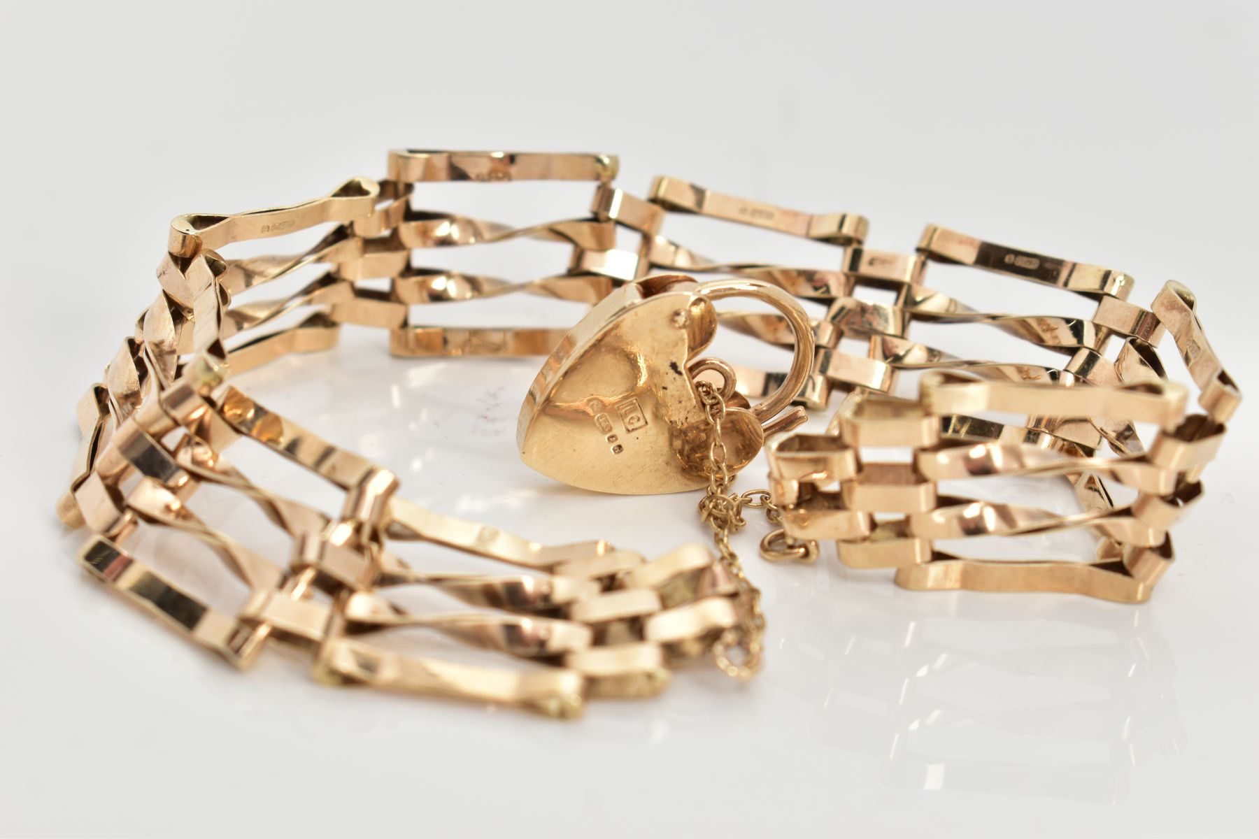 A 9CT GOLD GATE BRACELET, four bar polished yellow gold gate bracelet, fitted with a heart padlock - Image 2 of 2