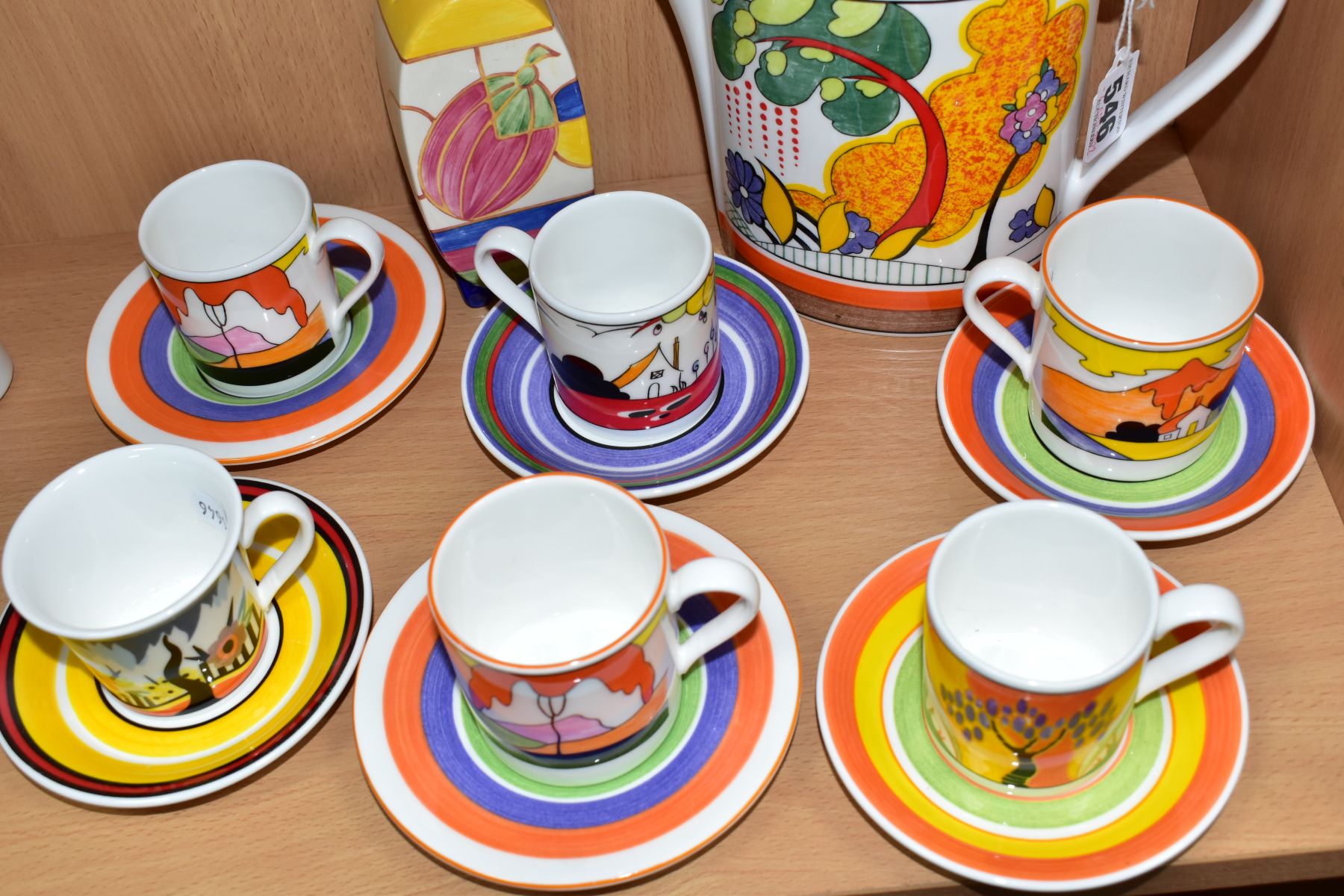 A WEDGWOOD CLARICE CLIFF COFFEE POT, SUGAR SIFTER AND SIX COFFEE CANS AND SAUCERS, comprising a - Image 3 of 7