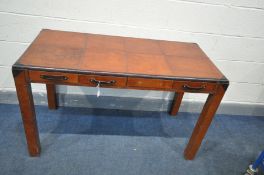 A BROWN PATCHED LEATHER WRAPPED DESK, possibly made by 'Coach house', with four frieze drawers, on
