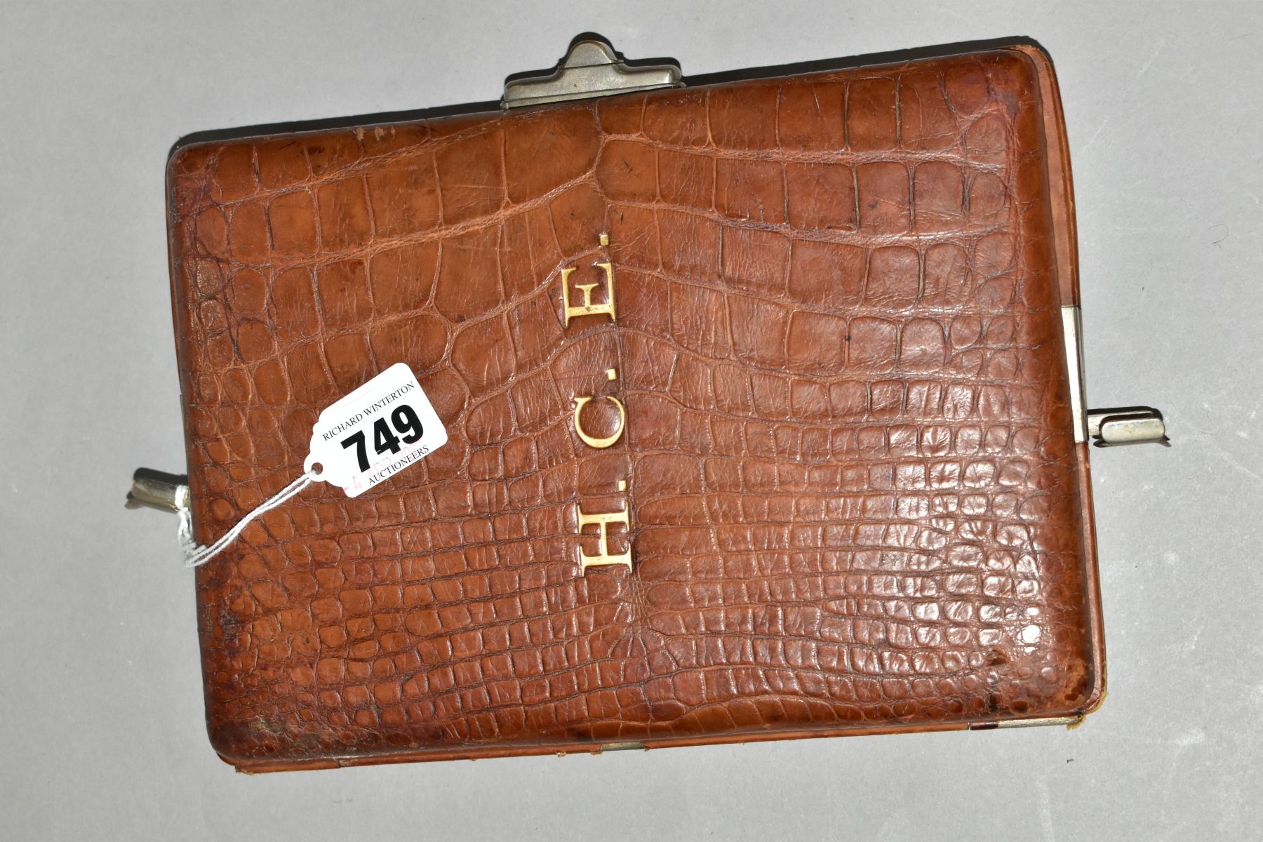 A TAN CROCODILE SKIN WRITING CASE, the cover embossed in gilt H.C.E., bears label for Ward to the