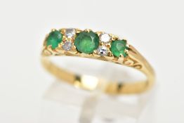 AN EMERALD AND DIAMOND RING, three circular cut diamonds set with four round brilliant cut diamonds,