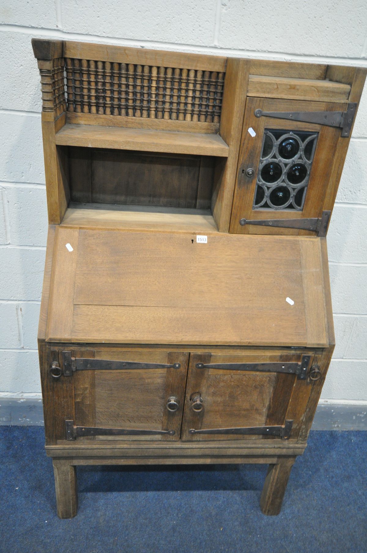 AN EARLY 20TH CENTURY OAK BUREAU, labelled Liberty & Co, in the Moorish style, the top section