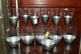 A SUITE OF JOHN LEWIS DRINKING GLASSES, comprising a set of six hammered silver effect wine