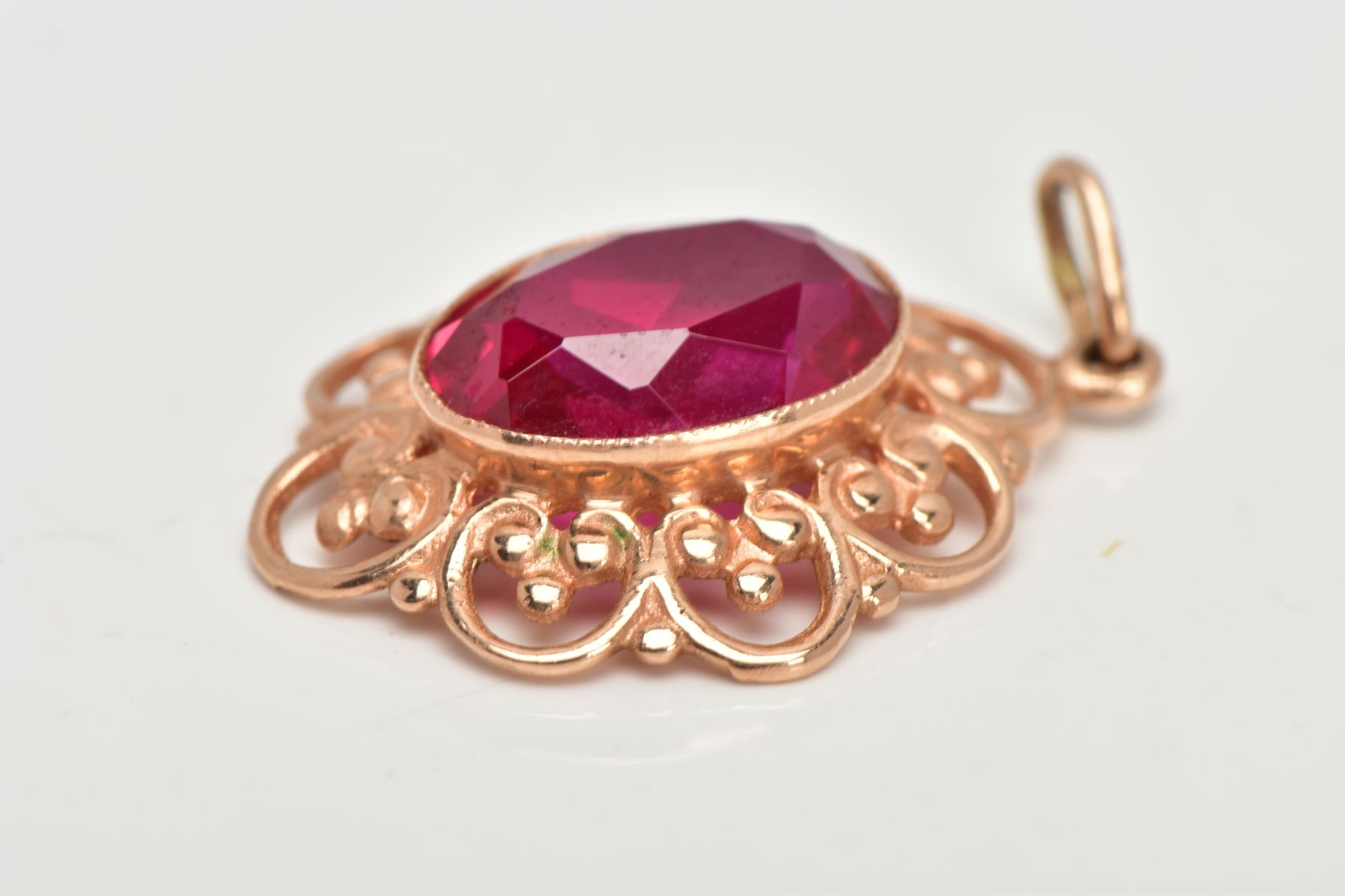 A YELLOW METAL SYNTHETIC RUBY PENDANT, designed with a central oval cut synthetic ruby, - Image 2 of 5