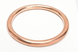 A ROSE GOLD TONE ARM BANGLE, plain polished rose gold design, stamped '9ct PPLd', approximate