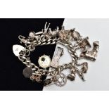 A HEAVY SILVER CHARM BRACELET, curb link bracelet each link stamped with a sterling mark, fitted