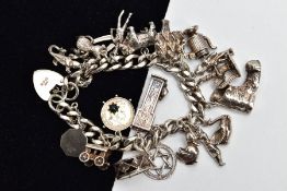 A HEAVY SILVER CHARM BRACELET, curb link bracelet each link stamped with a sterling mark, fitted