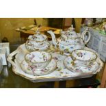 A LATE 19TH CENTURY CONTINENTAL PORCELAIN TETE-A-TETE SET, hand painted with floral sprays,