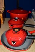 FOUR LE CREUSET ENAMEL PANS, each in red enamel over cast iron, comprising 23cm skillet pan, two