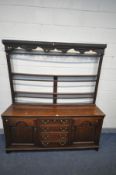 A GEORIAN OAK DRESSER, the two tier plate rack top, over a base with double fielded panel cupboard
