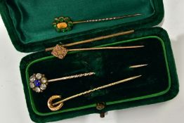 FOUR STICK PINS, to include a blue and colourless paste cluster stick pin, unmarked, a 9ct gold