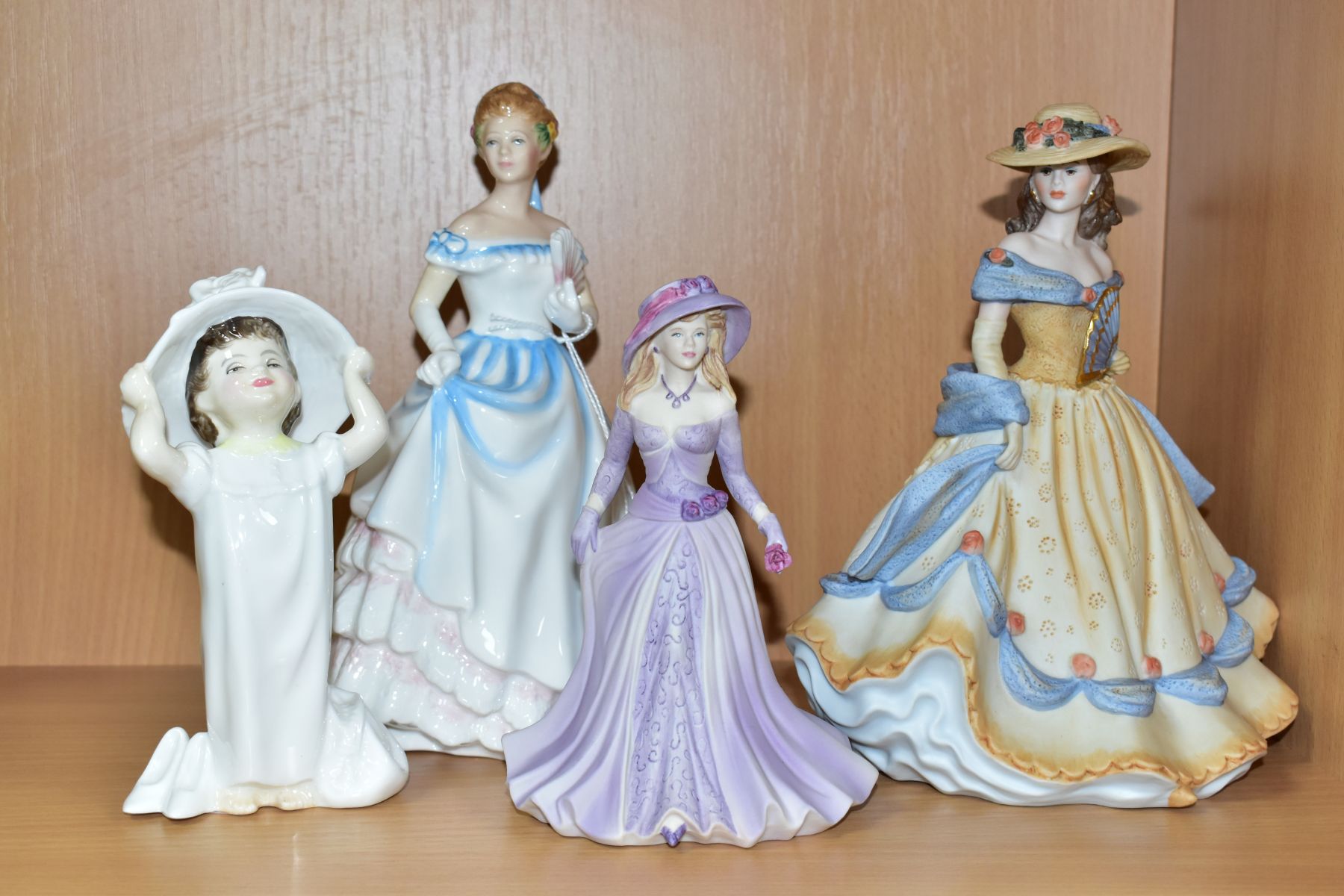 A GROUP OF FOUR CERAMIC FIGURINES, comprising Royal Doulton Claire HN3646 and Make Believe HN2224,