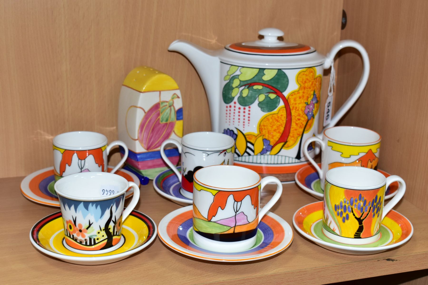 A WEDGWOOD CLARICE CLIFF COFFEE POT, SUGAR SIFTER AND SIX COFFEE CANS AND SAUCERS, comprising a