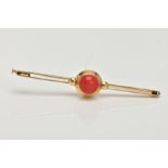 A YELLOW METAL CORAL BAR BROOCH, circular red coral cabochon, approximate width 9mm, set in a yellow