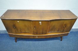 A BEAUTILITY WALNUT SIDEBOARD, with central pull out drinks section flanked by double cupboard,