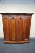 A LATE VICTORIAN FLAME MAHOGANY BREAKFRONT WARDROBE, with overhanging cornice, four doors with a