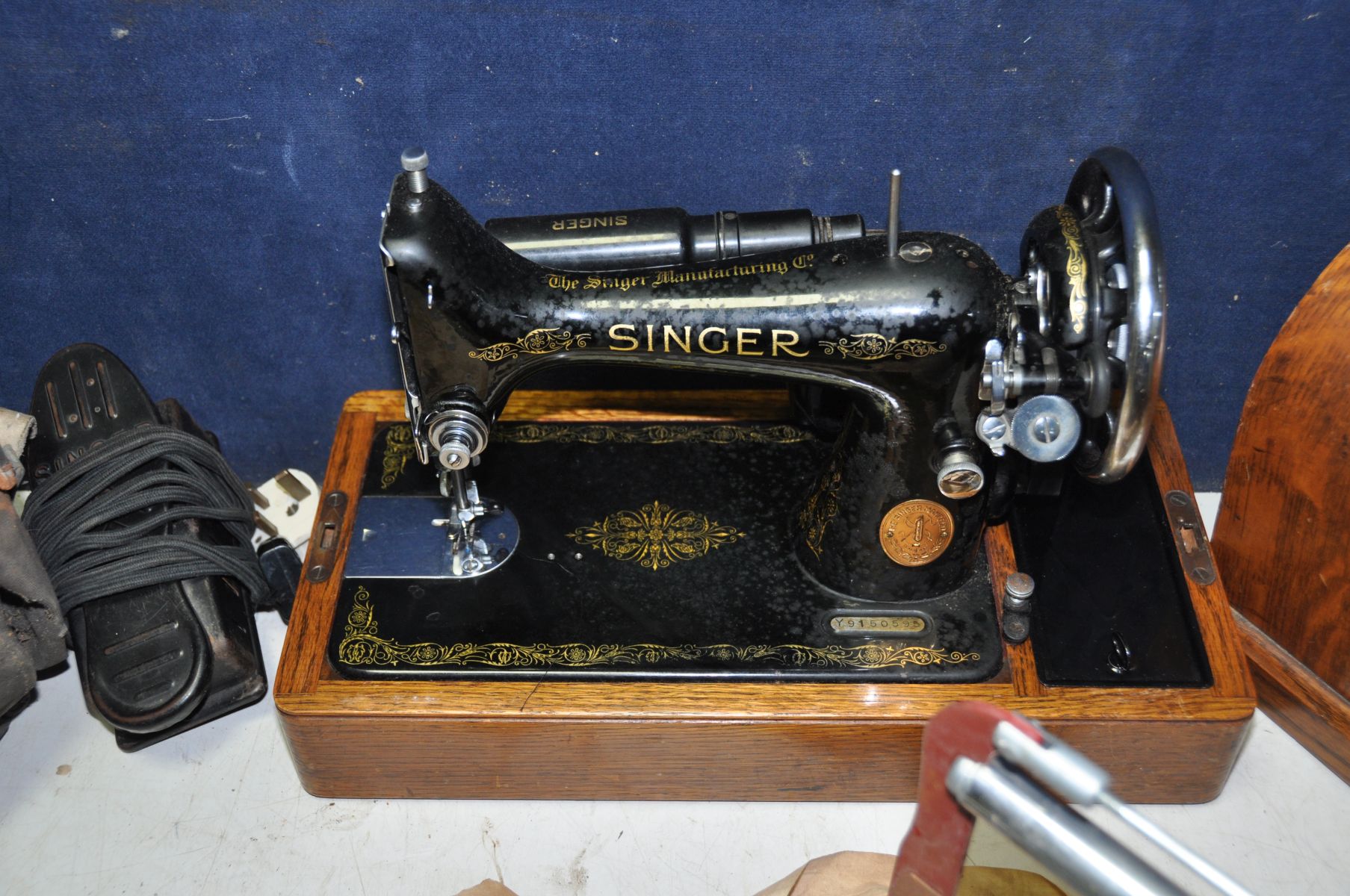 A SINGER SEWING MACHINE with foot peddle along with a bag containing vintage bicycle parts a - Image 2 of 4