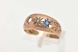 A 9CT GOLD STAR SET DIAMOND RING, an old cut diamond and a blue paste in a star setting, dome shaped