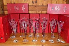 A SET OF TWELVE LIMITED EDITION BOXED WATERFORD CRYSTAL 'TWELVE DAYS OF CHRISTMAS' CHAMPAGNE FLUTES,