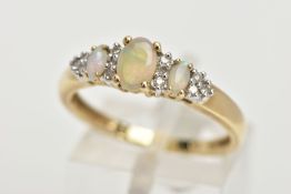 A 9CT GOLD OPAL AND DIAMOND RING, an oval opal and two marquise shaped opals set with ten round