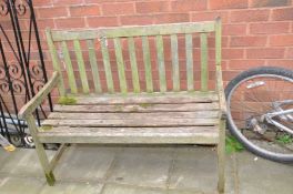 A WEATHERED HARDWOOD GARDEN BENCH with slatted seat and back width 108cm