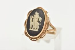 A 9CT GOLD WEDGWOOD RING, of an oval design set with a black and white cameo, bezel set with a