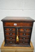 A LATE 19TH/EARLY 20TH CENTURY OAK ENGINEERS/JEWELLERY CABINET, with a hinged top compartment,